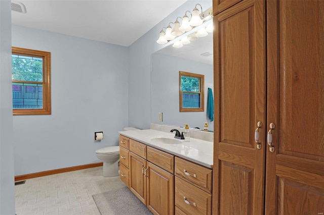 7102 Shadow Ln, Villa Ridge, MO 63089 - bathroom with toilet, vanity, baseboards, and tile patterned floors