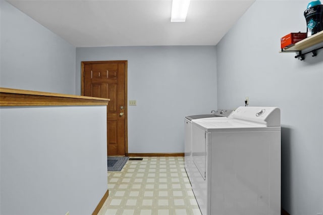 7102 Shadow Ln, Villa Ridge, MO 63089 - clothes washing area with washer and clothes dryer, light flooring, and baseboards