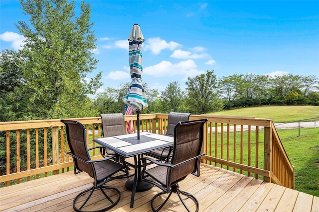7102 Shadow Ln, Villa Ridge, MO 63089 - wooden deck featuring outdoor dining area and a lawn