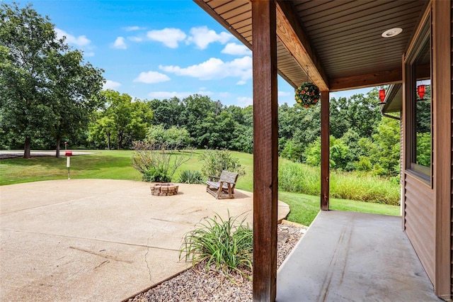 7102 Shadow Ln, Villa Ridge, MO 63089 - view of patio / terrace featuring view of wooded area and a fire pit