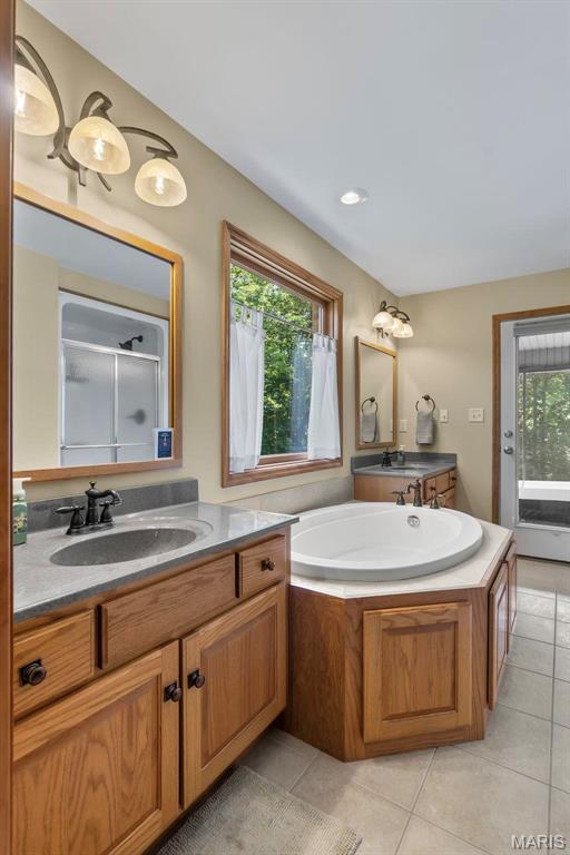 304 Timberlake Ln, Cape Girardeau, MO 63701 - bathroom with vanity, tile patterned floors, a shower stall, and a bath
