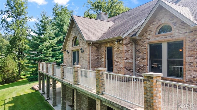 304 Timberlake Ln, Cape Girardeau, MO 63701 - view of home's exterior with roof with shingles, brick siding, a yard, a wooden deck, and a chimney