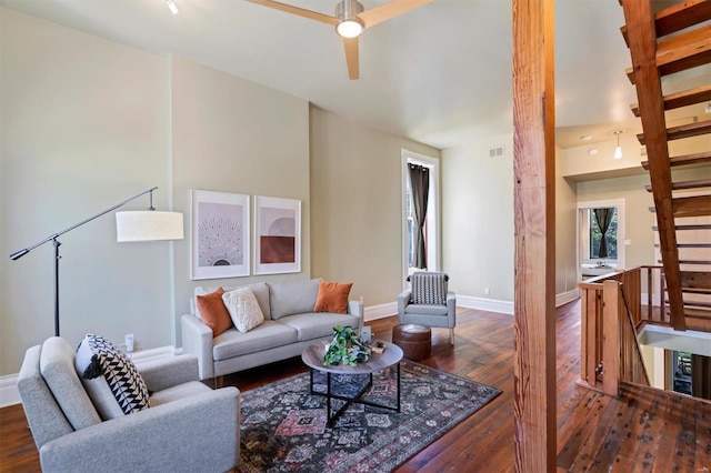 living area with hardwood / wood-style floors, baseboards, and a ceiling fan