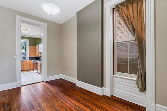 spare room with light wood-style floors and baseboards