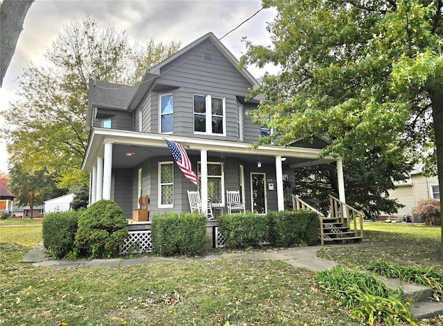 view of front of home featuring a porch and a front lawn