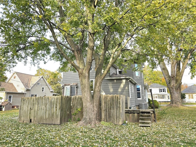 view of yard with fence and central AC unit