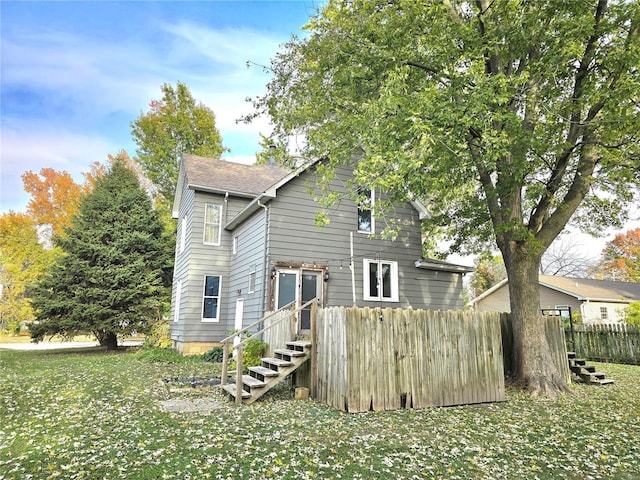 rear view of house with fence