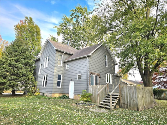 view of side of home featuring roof with shingles and a wooden deck