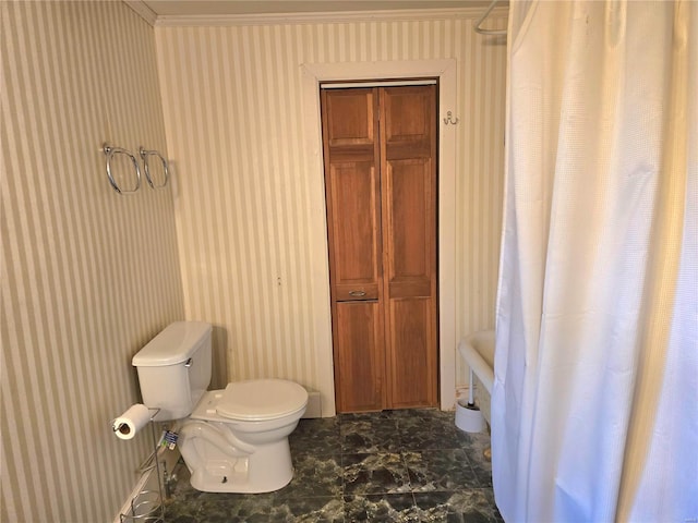 bathroom with toilet, wallpapered walls, crown molding, and marble look tile flooring