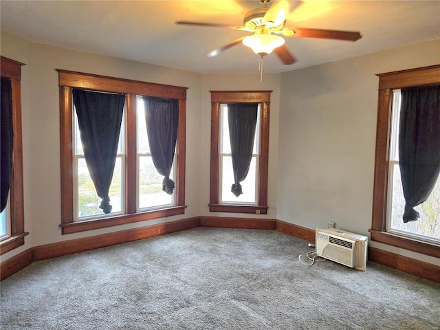unfurnished room featuring carpet, ceiling fan, baseboards, and a wall mounted AC