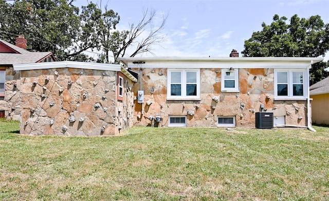 791 N Adams Ave N, Lebanon, MO 65536 - rear view of property with central AC unit, a yard, a chimney, and stone siding