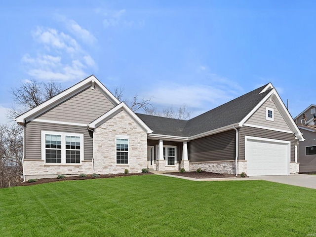 2475 Chukka Dr, Eureka, MO 63025 - view of front of home with stone siding, driveway, a front yard, and an attached garage