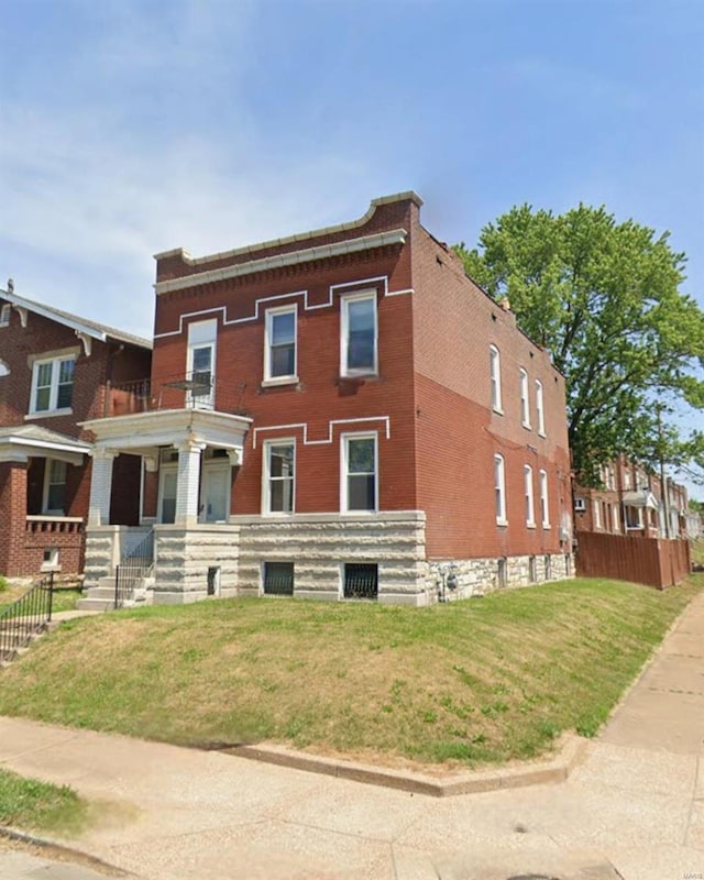3101 Osage St, Saint Louis, MO 63118 - view of front of house featuring a front yard, a balcony, covered porch, and brick siding
