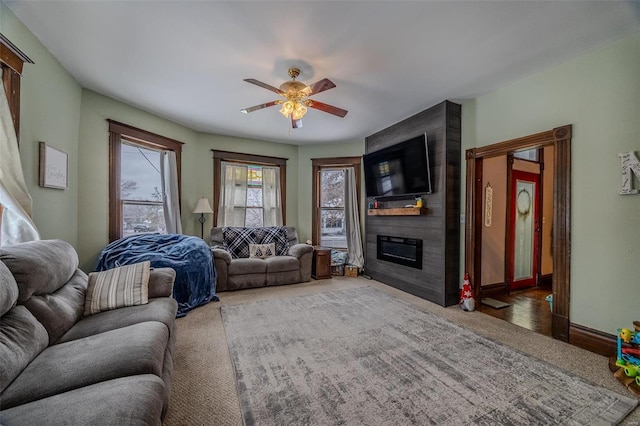 607 N Jackson St, Salem, MO 65560 - carpeted living area with a fireplace, a ceiling fan, and baseboards