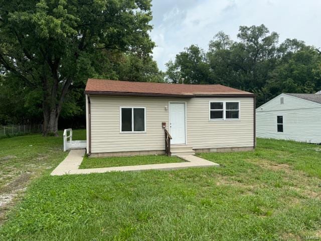 back of house with a yard and entry steps