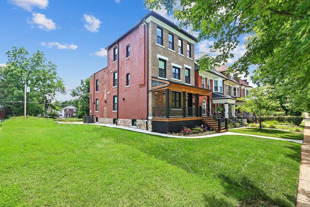 5640 Maple Ave, Saint Louis, MO 63112 - view of side of property with covered porch, brick siding, a lawn, and central AC unit