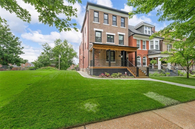 5640 Maple Ave, Saint Louis, MO 63112 - view of front of home featuring covered porch, brick siding, and a front lawn