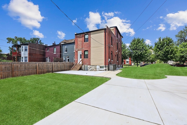 5640 Maple Ave, Saint Louis, MO 63112 - back of house featuring entry steps, central AC, brick siding, and a patio