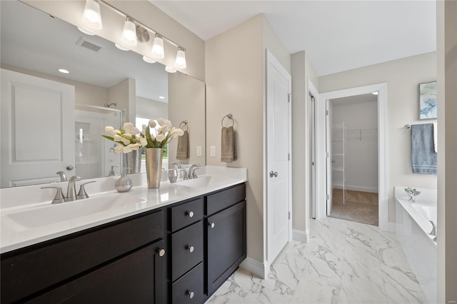 4947 Butler Hill Rd, Saint Louis, MO 63128 - full bathroom featuring a shower stall, marble look tiles, baseboards, double vanity, and a bath