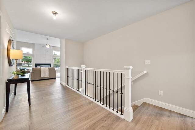 4947 Butler Hill Rd, Saint Louis, MO 63128 - corridor with an upstairs landing, baseboards, and wood finished floors