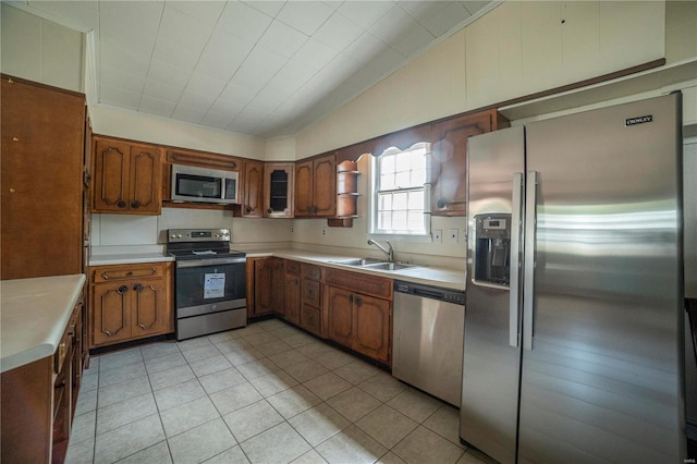 400 W W, New London, MO 63459 - kitchen with appliances with stainless steel finishes, a sink, brown cabinetry, light countertops, and vaulted ceiling