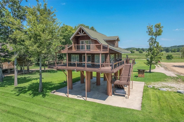 back of house featuring a patio, a wooden deck, a yard, and stairway