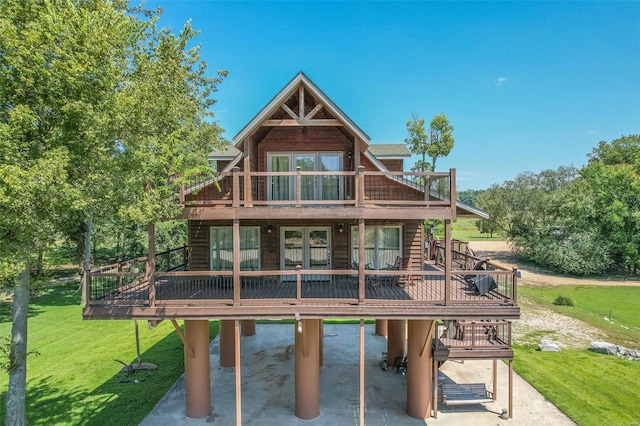 back of house with a wooden deck, a lawn, stairs, and french doors