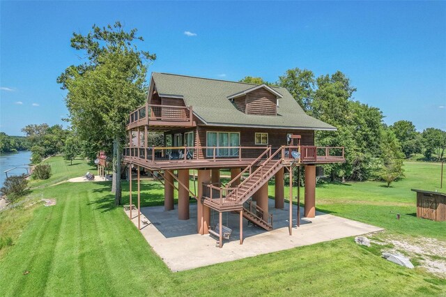 view of play area with a patio area, a yard, a wooden deck, and stairs