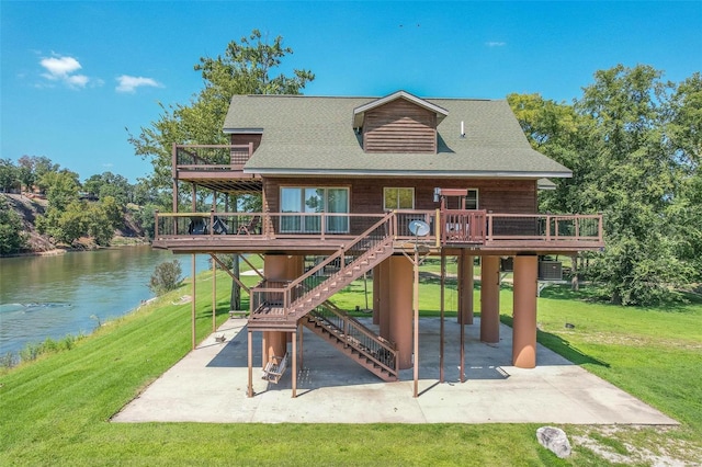 view of jungle gym with a patio area, a lawn, a deck with water view, and central AC