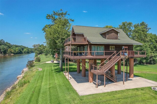 view of jungle gym with a patio area, a lawn, a deck with water view, and stairs
