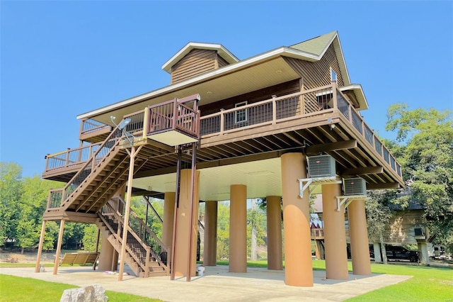 back of property featuring stairs and a wooden deck