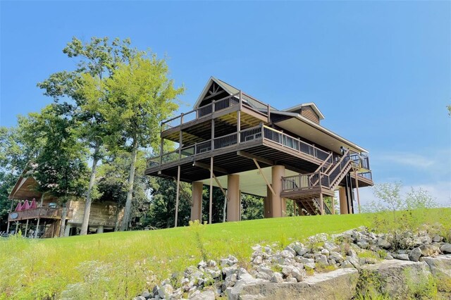 back of property with a wooden deck and stairway