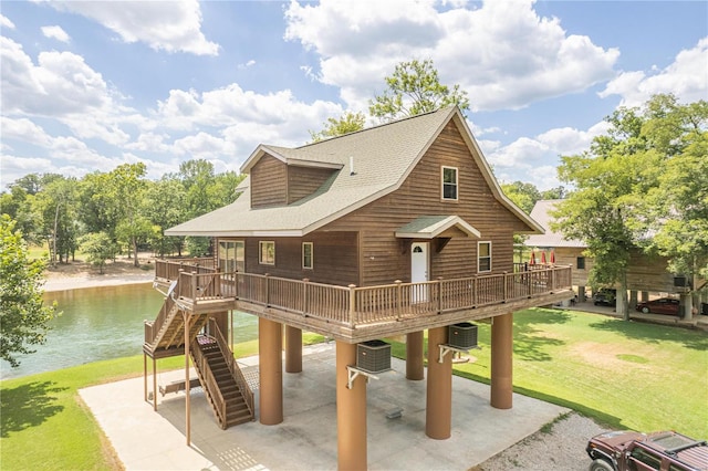 view of play area featuring a patio area, a deck with water view, a yard, stairs, and cooling unit