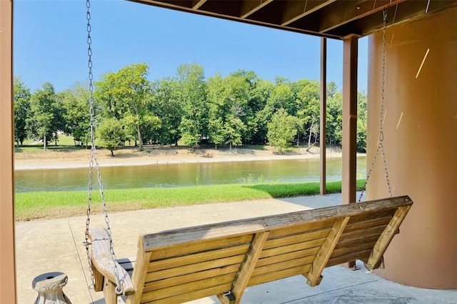 view of patio / terrace featuring a water view and view of scattered trees