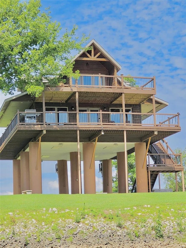 back of house featuring a wooden deck and stairway