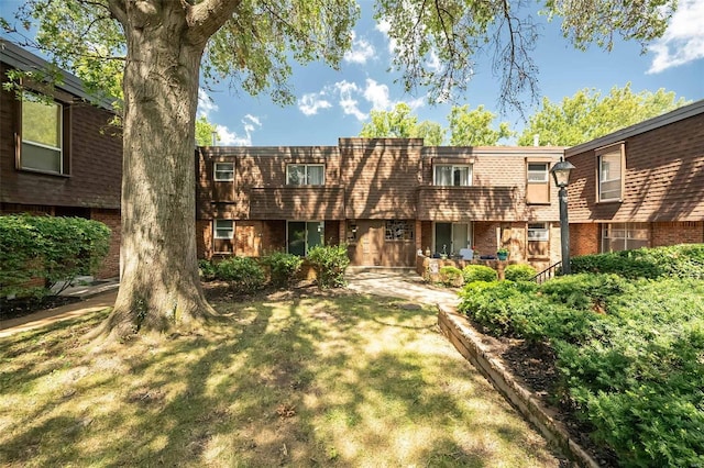 13579 Coliseum Dr Unit G, Chesterfield, MO 63017 - view of front facade featuring brick siding, a front lawn, and mansard roof