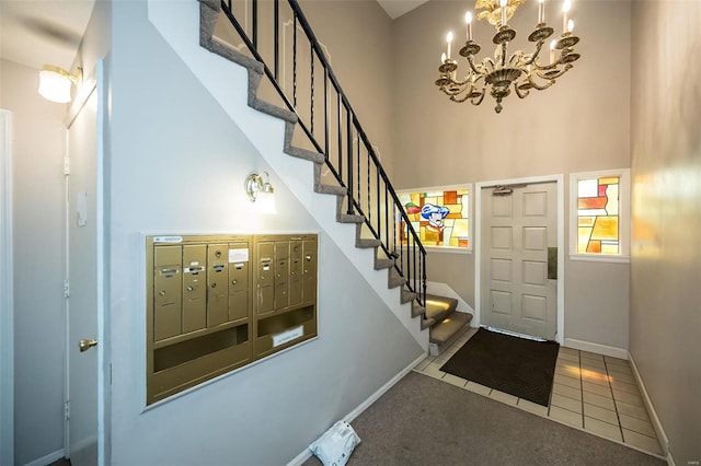 13579 Coliseum Dr Unit G, Chesterfield, MO 63017 - entrance foyer featuring stairs, baseboards, a high ceiling, tile patterned flooring, and a chandelier