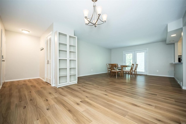 13579 Coliseum Dr Unit G, Chesterfield, MO 63017 - dining space with french doors, light wood finished floors, a chandelier, and baseboards