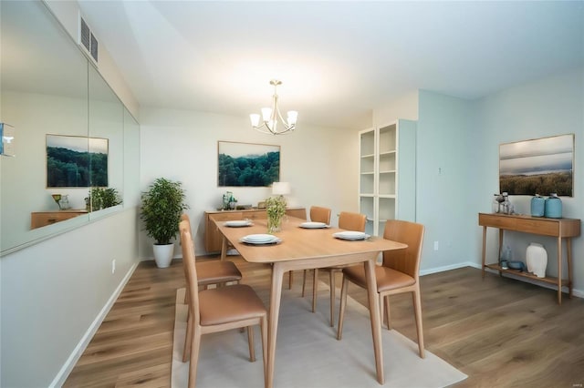 13579 Coliseum Dr Unit G, Chesterfield, MO 63017 - dining room featuring wood finished floors, a chandelier, and baseboards