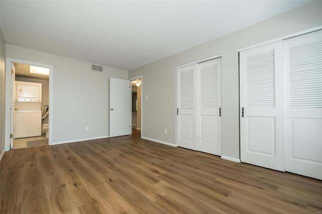13579 Coliseum Dr Unit G, Chesterfield, MO 63017 - unfurnished bedroom with multiple closets, wood finished floors, baseboards, and ensuite bathroom