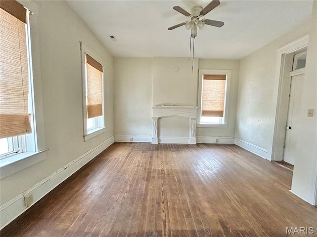 410 N Main St, Red Bud, IL 62278 - unfurnished living room featuring wood-type flooring, a ceiling fan, plenty of natural light, and baseboards