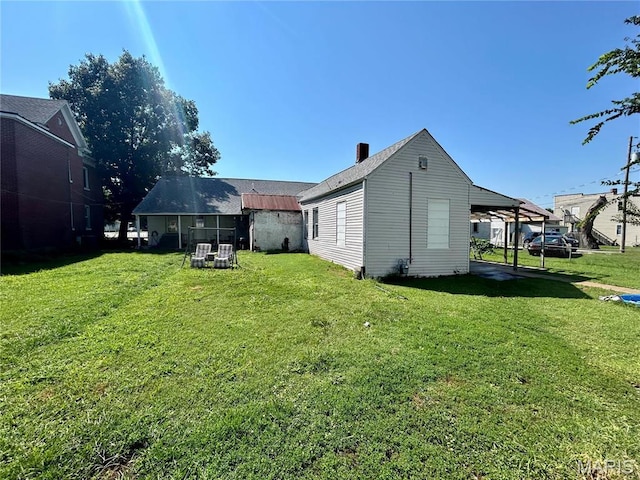 410 N Main St, Red Bud, IL 62278 - rear view of house featuring a yard and a chimney