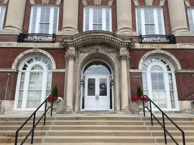 property entrance with brick siding and french doors