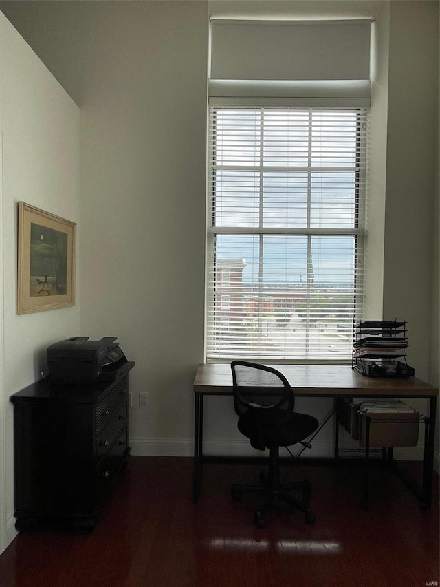 office area featuring baseboards and dark wood-type flooring