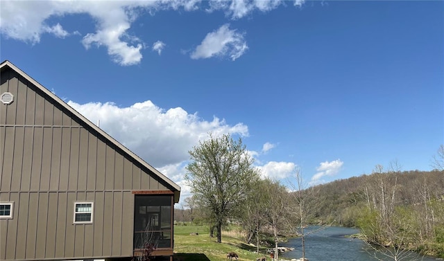 347 Big Trout Trl, Mammoth Spring, AR 72554 - view of side of home featuring board and batten siding, a water view, and a sunroom