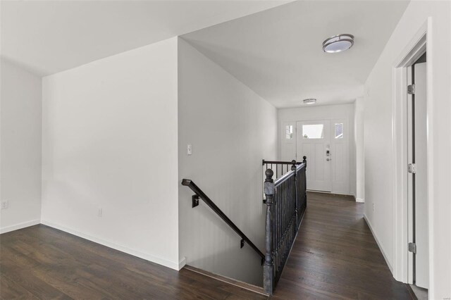 106 Harrow Dr, Ofallon, MO 63385 - hallway with an upstairs landing, dark wood finished floors, and baseboards