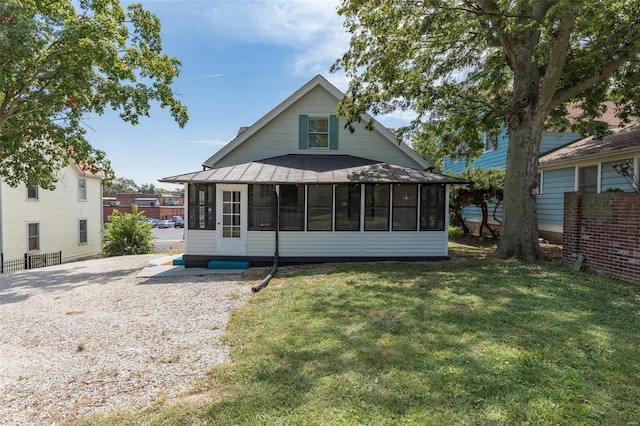 371 Jefferson St, Saint Genevieve, MO 63670 - back of property with a sunroom, a yard, and a standing seam roof