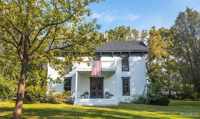 725 W Springfield St, St James, MO 65559 - view of front of house featuring a balcony, french doors, a front yard, and brick siding