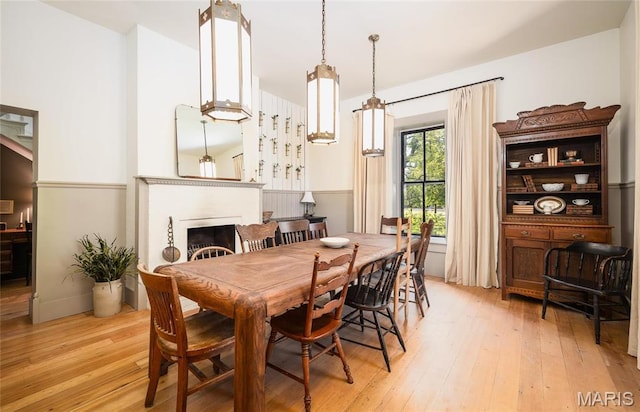 725 W Springfield St, St James, MO 65559 - dining space with light wood-style flooring and a fireplace