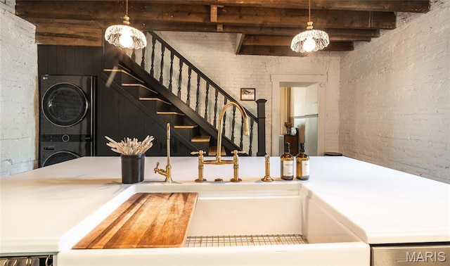 725 W Springfield St, St James, MO 65559 - stairs featuring stacked washer / drying machine, a chandelier, and brick wall